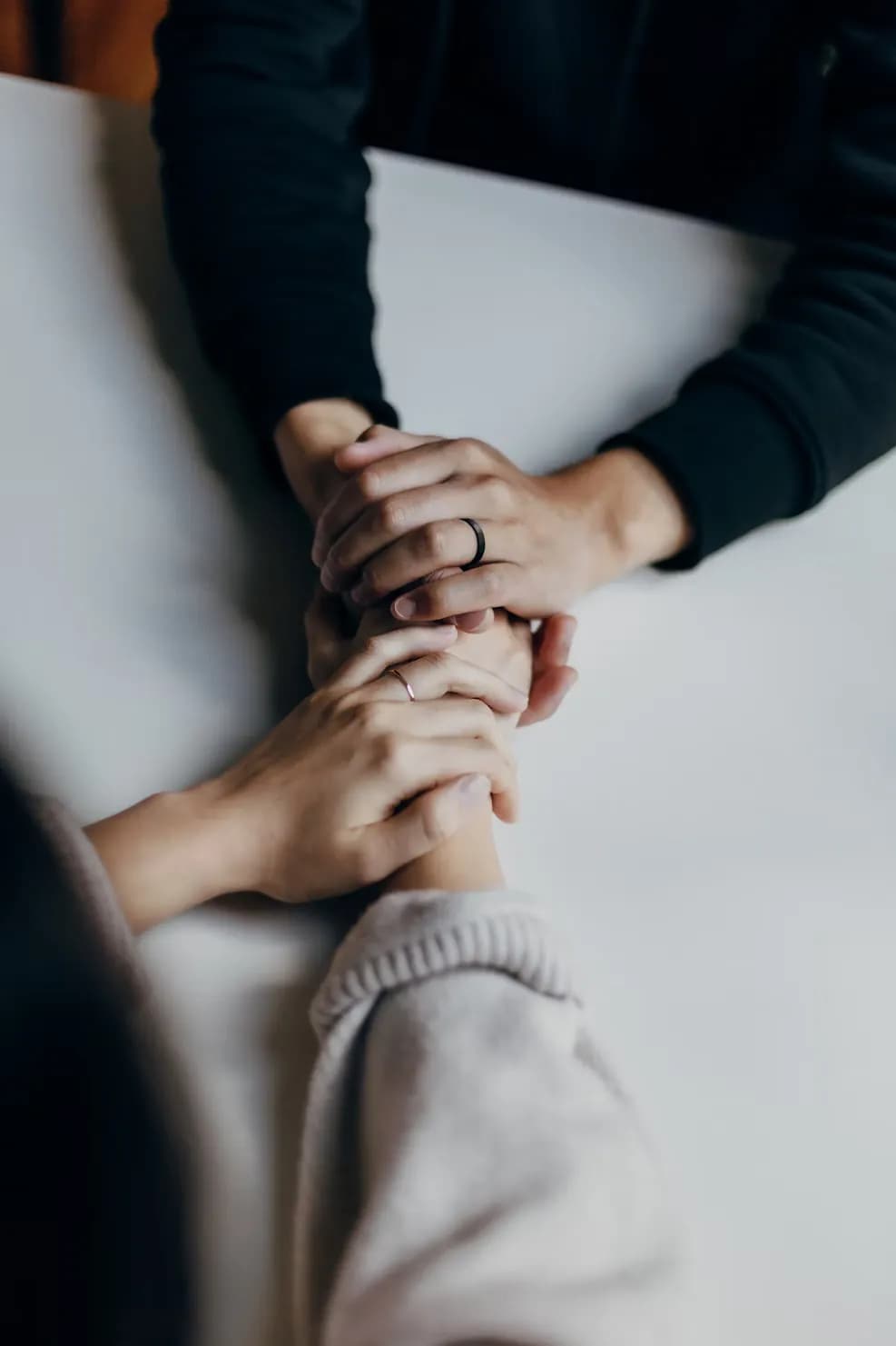 Hands during a marriage counseling session in Riga